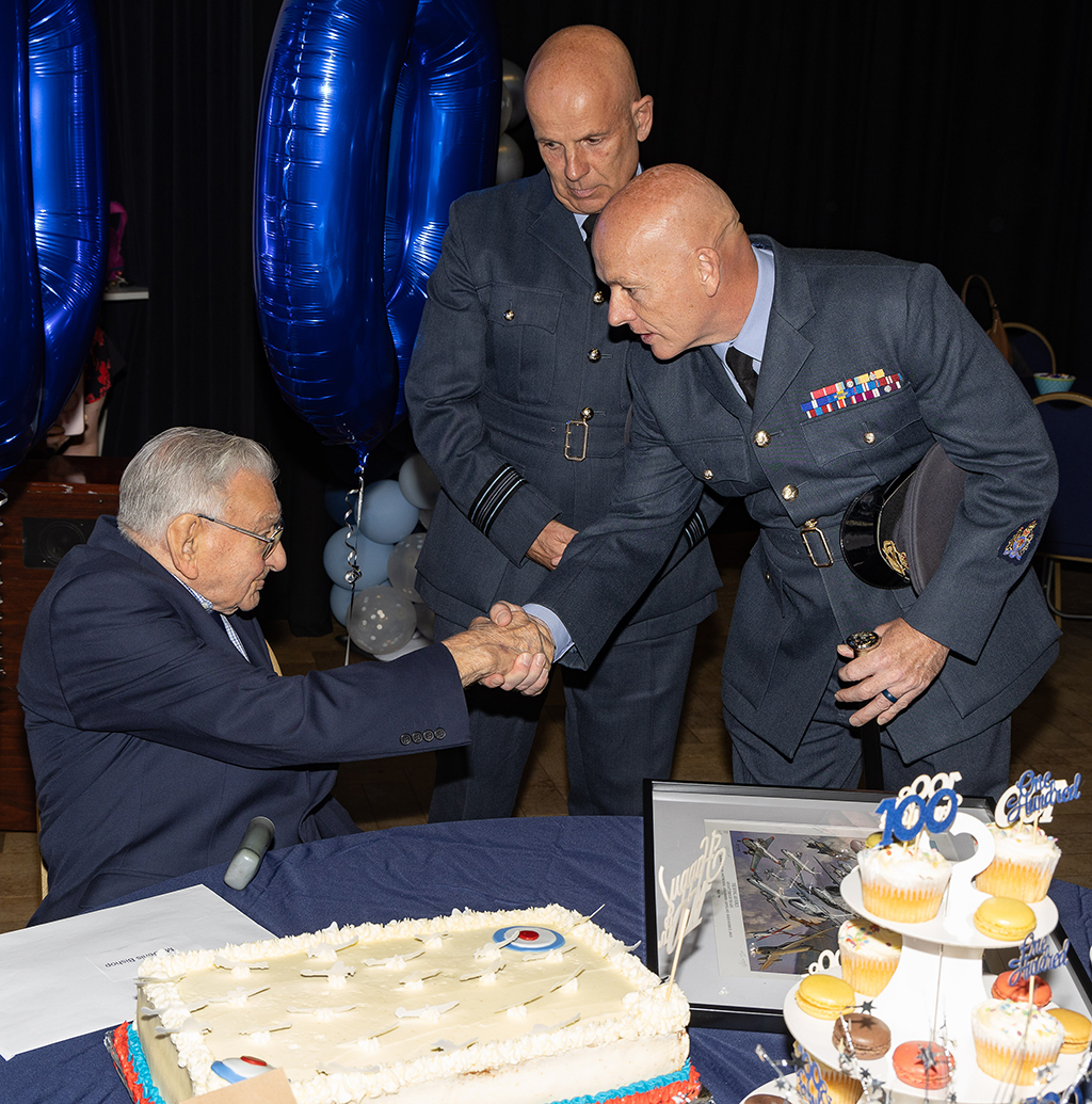Service representatives from RAF Brize Norton shake the hand of Denis Bishop.
